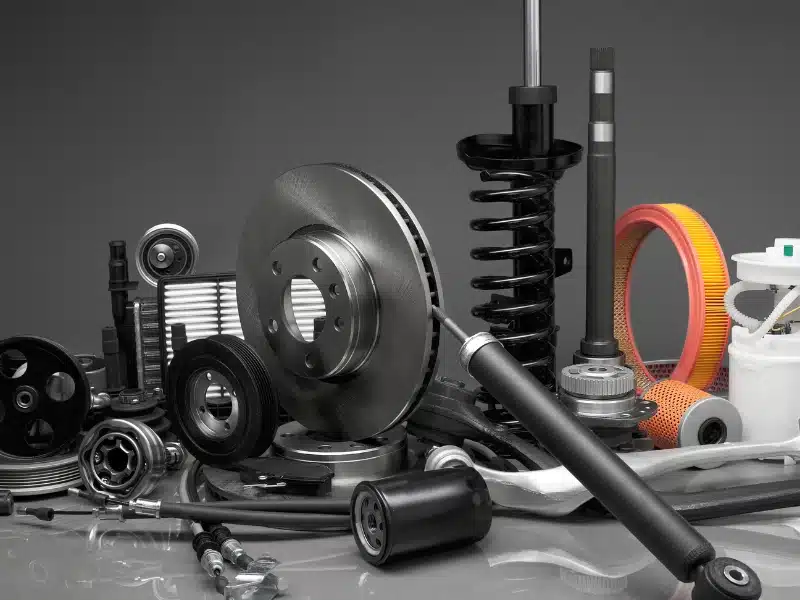 Collection of metal and composite machine parts produced through advanced 3D printing technology for military use, including gears, springs, filters, and brake components.