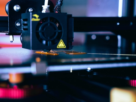 A 3D printer in action, creating a complex object layer by layer, showcasing innovative manufacturing technology.